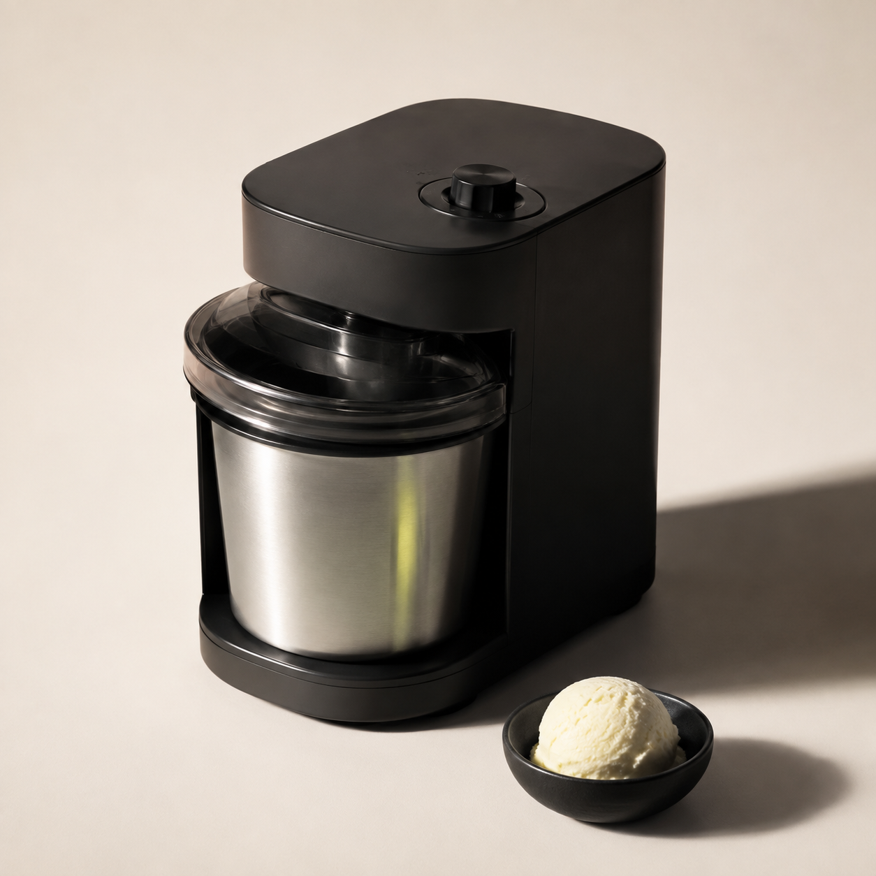 Unbranded black dessert maker photographed in a warm editorial studio